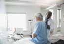doctor checking senior mans back in examination room 547016317 593e24093df78c537b7df01f.jpg